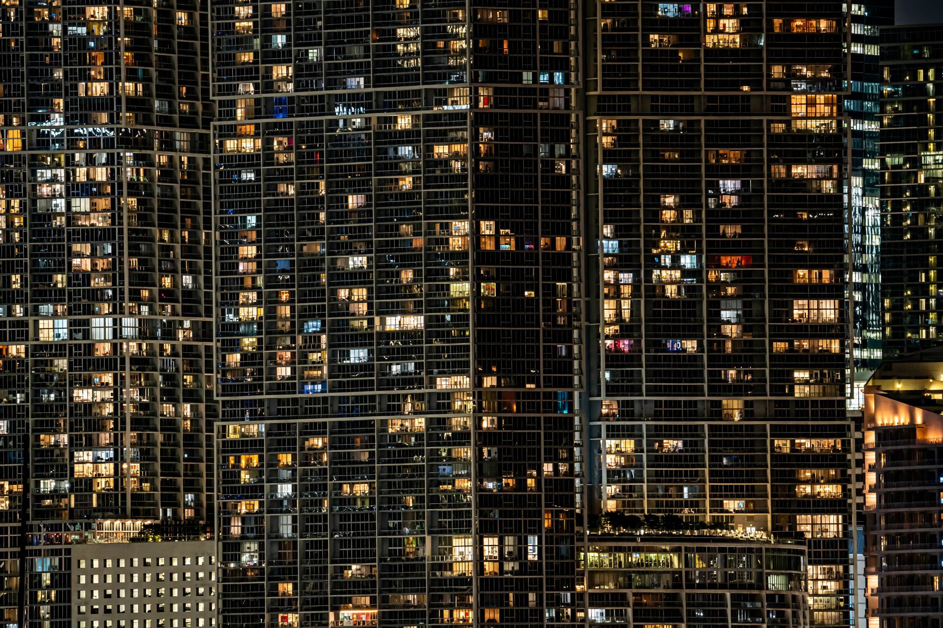 aerial view of the Tel Aviv skyline at dusk with modern glass office towers lit against a fading sky, no identifiable signage