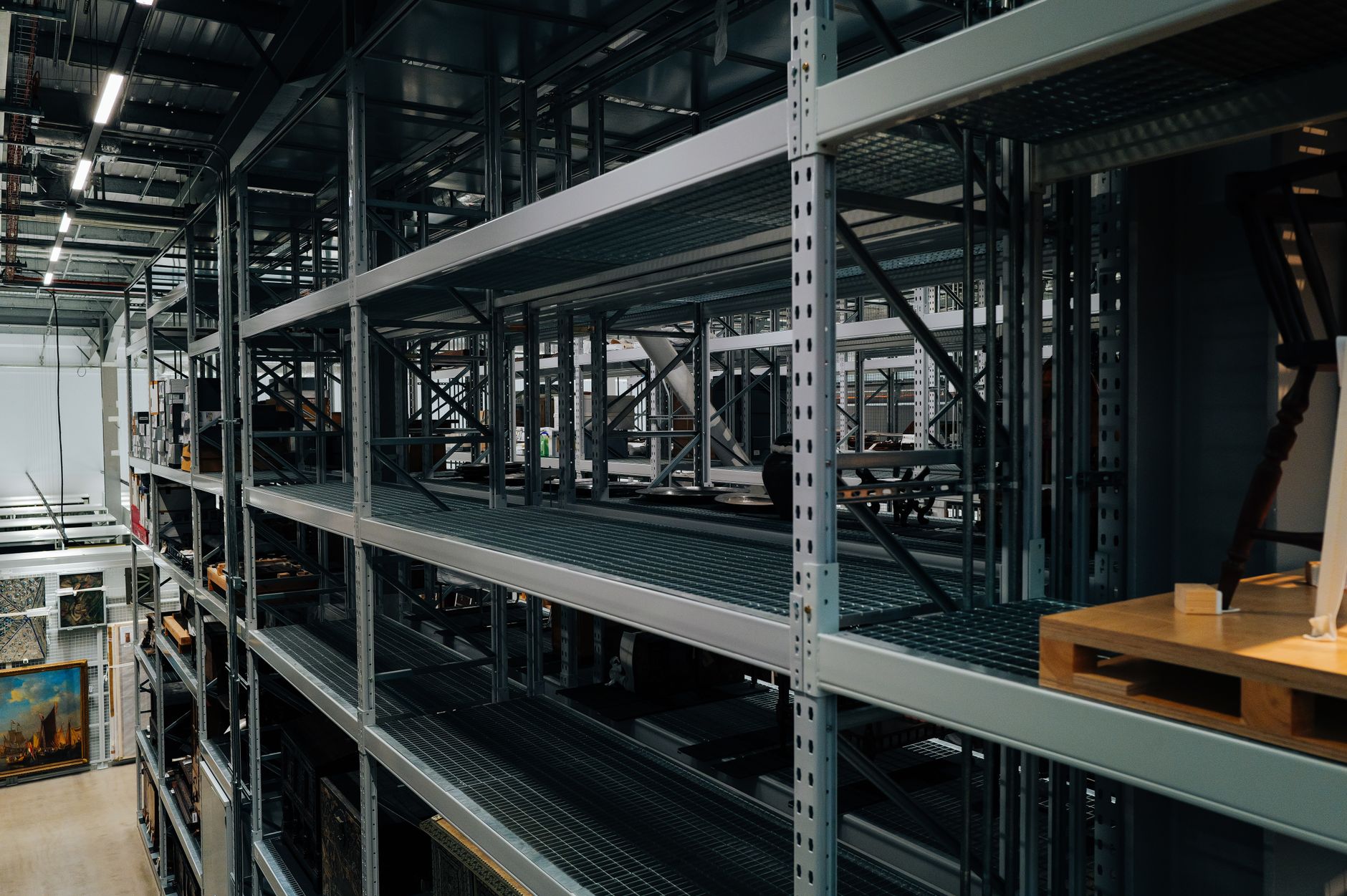 close-up of military ordnance stacked in a secure warehouse facility, with metal shelving and industrial lighting