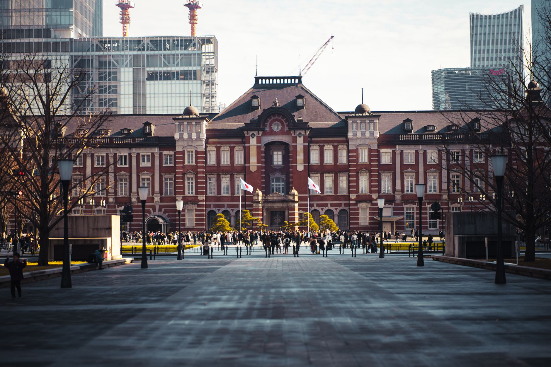 exterior of the Bank of Japan headquarters building in Tokyo at midday, with a wide stone facade and landscaped courtyard visible