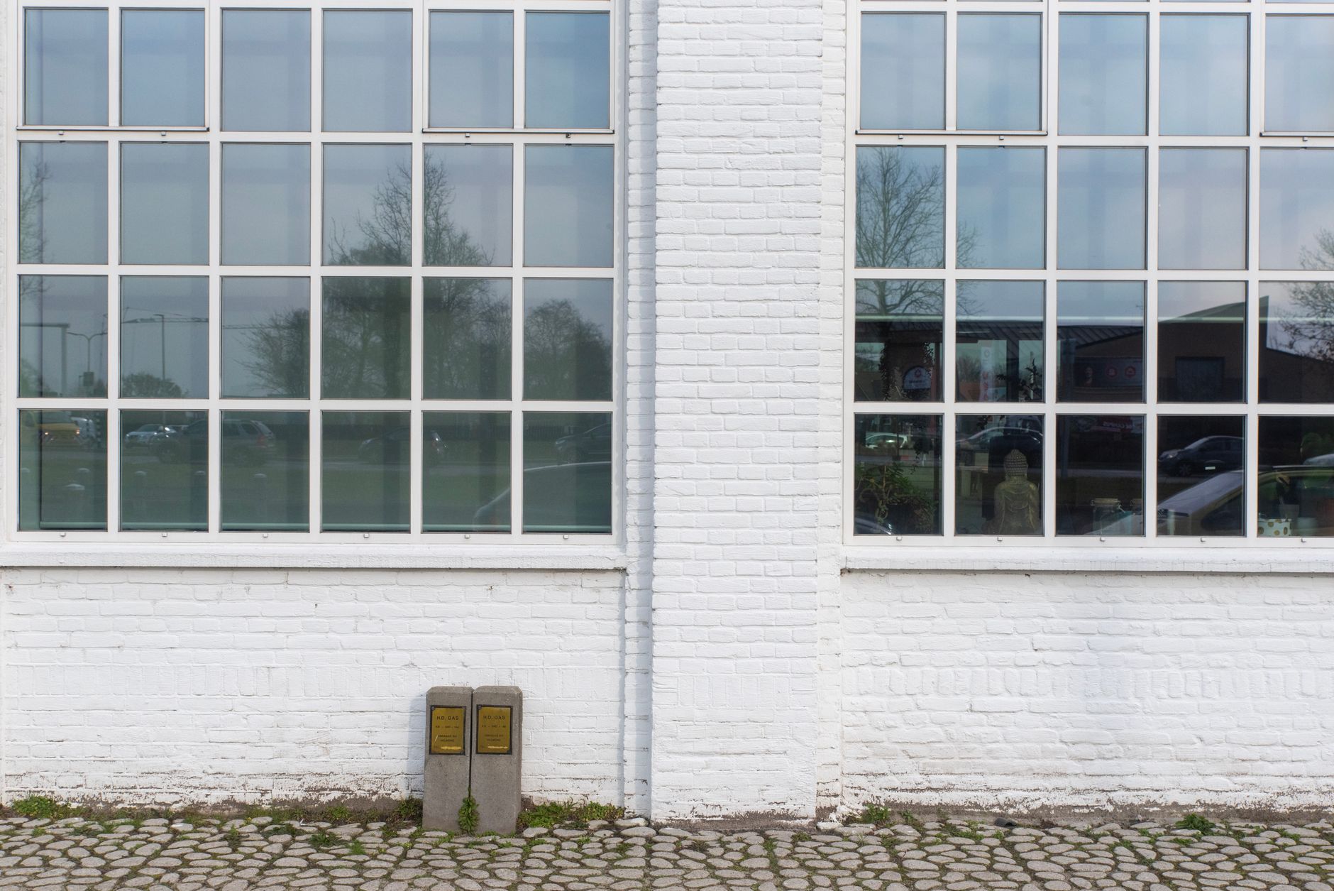 exterior view of a Bureau of Indian Standards testing laboratory building, with signage visible and scientific equipment seen through large glass windows