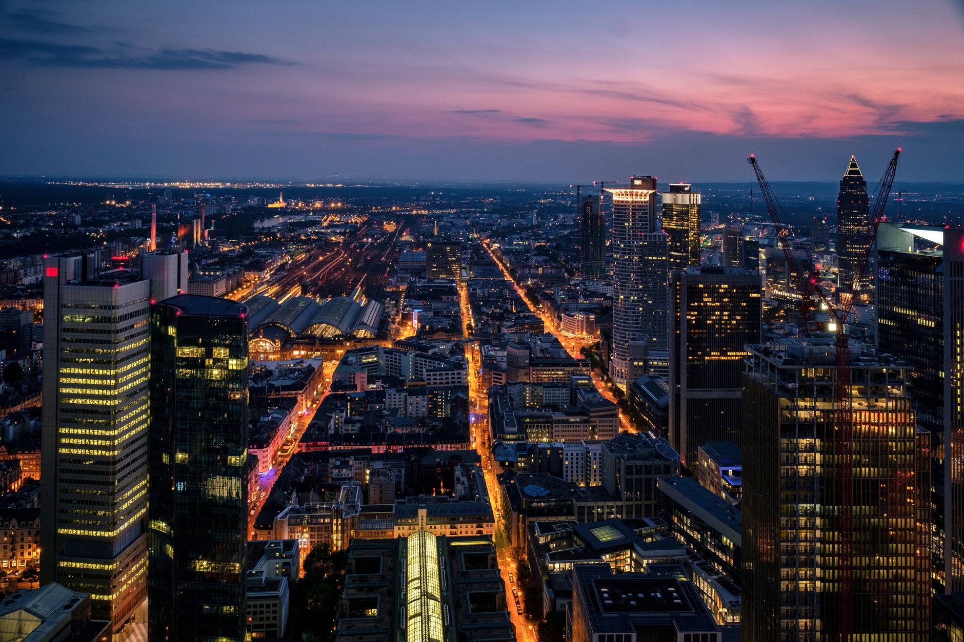 aerial view of Tel Aviv's technology district at dusk, office towers with illuminated windows visible against a darkening skyline