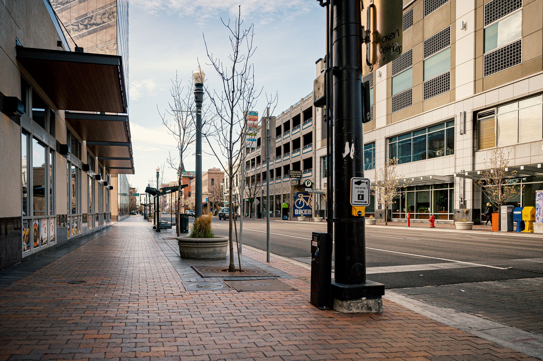 rows of commercial bank branch facades along a busy urban financial district street, signage and glass storefronts in focus
